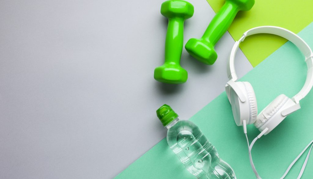 flat-lay-frame-with-headphones-dumbbells