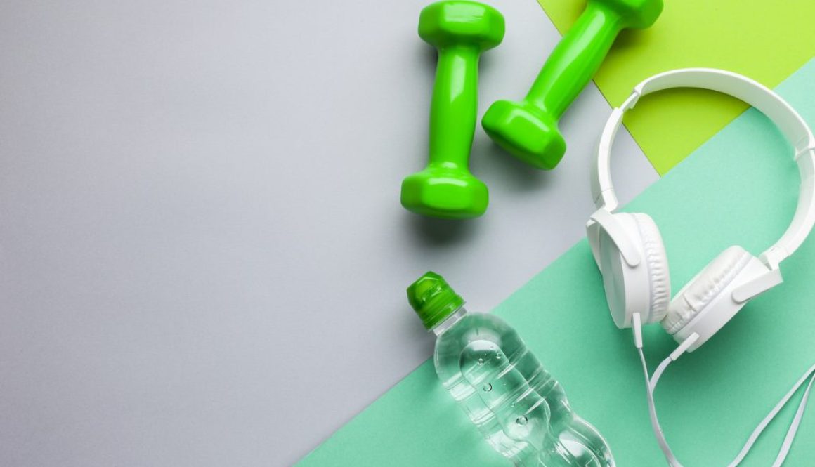 flat-lay-frame-with-headphones-dumbbells